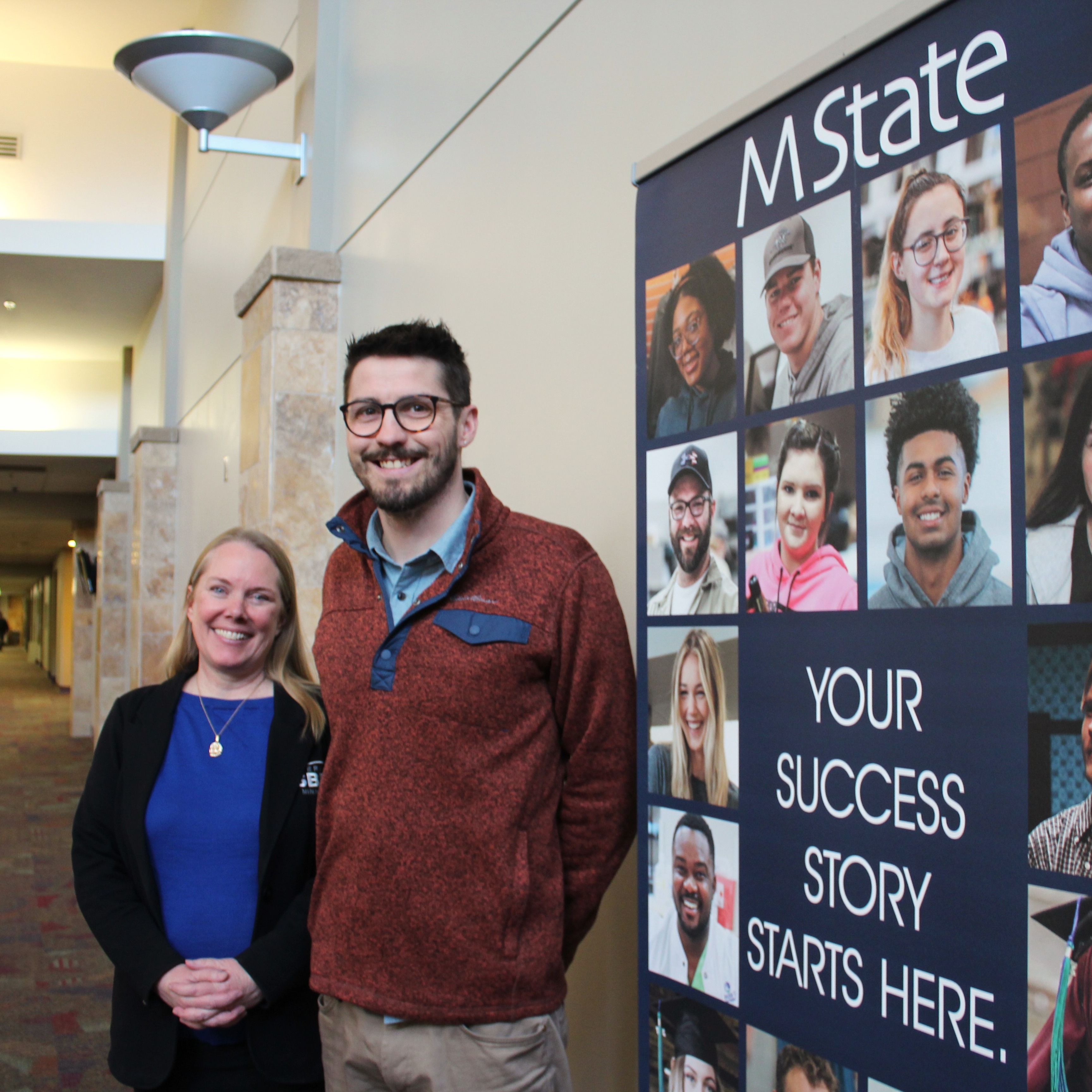 Amy Anderson and Ian Carlstrom, of the West Central 첥 SBDC, pose for a picture outside their office on M State's Moorhead campus.